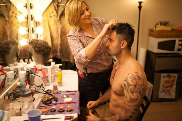 Hair Supervisor Susan Corrado performs some pre-show hair styling on Ramin Karimloo.  Photo