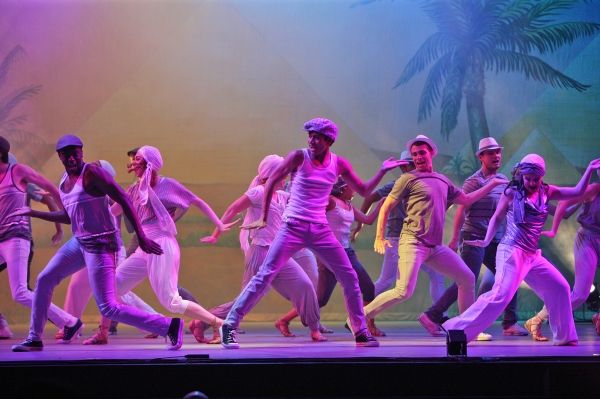 The cast celebrates a Megamix, bathed in lighting by David Neville. Photo