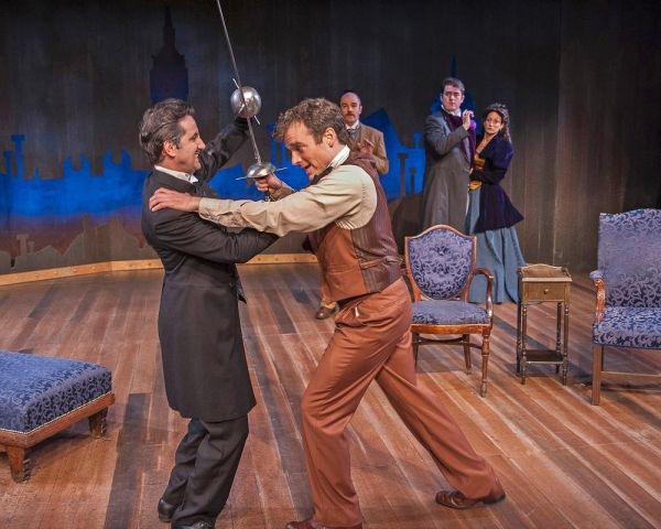 David Gautschy as Professor Moriarty and Nate Washburn as Sherlock Holmes with (in th Photo