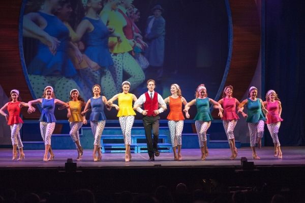 Frank Abagnale Jr. (Skyler Adams) surrounds himself with pretty dancers, 1960s TV sty Photo