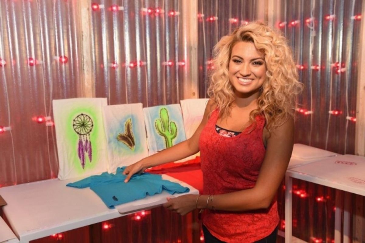 Tori Kelly designs a t-shirt at a special event for Arizona Jean Co at 