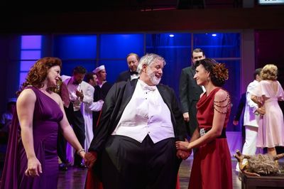 Actors Aled Davies (center, as Falstaff) shares the spotlight with the wise wives of  Photo