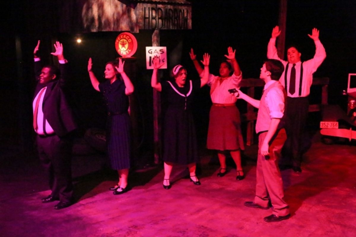 Clyde (Matt Pentecost, in front) holds up a shopkeeper in ''God''s Arms Are Always Open'' at 