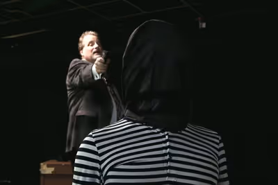 Tupolski (Scott Holmes) prepares to execute Katurian (Aaron Echegaray). Photo