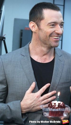 Extra offers Hugh Jackman a birthday cupcake at the meet & greet for ''The River'' at their rehearsal studio on October 14, 2014 in New York City. @ BroadwayWorld Extra offers Hugh Jackman a birthday cupcake at the meet & greet for ''The River'' a Photo