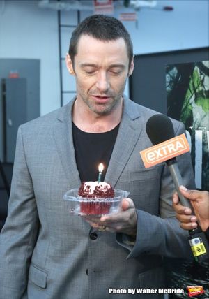 Extra offers Hugh Jackman a birthday cupcake at the meet & greet for ''The River'' at their rehearsal studio on October 14, 2014 in New York City. @ BroadwayWorld Extra offers Hugh Jackman a birthday cupcake at the meet & greet for ''The River'' a Photo