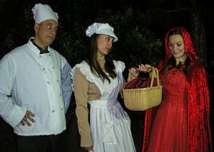 The Baker (Terry Delegeane) and his Wife (Amy Coles) give a basket of sweets to Little Red Ridinghood (Carly Linehan) to take to her Granny.  with Terry Delegeane, Amy Coles and Carly Linehan. @ BroadwayWorld The Baker (Terry Delegeane) and his Wife (Amy Coles) give a basket of sweets to Litt Photo