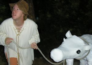  Jack (Brad Halvorsen) fearfully leads his cow Milky-White (Brandie June) into the wo Photo