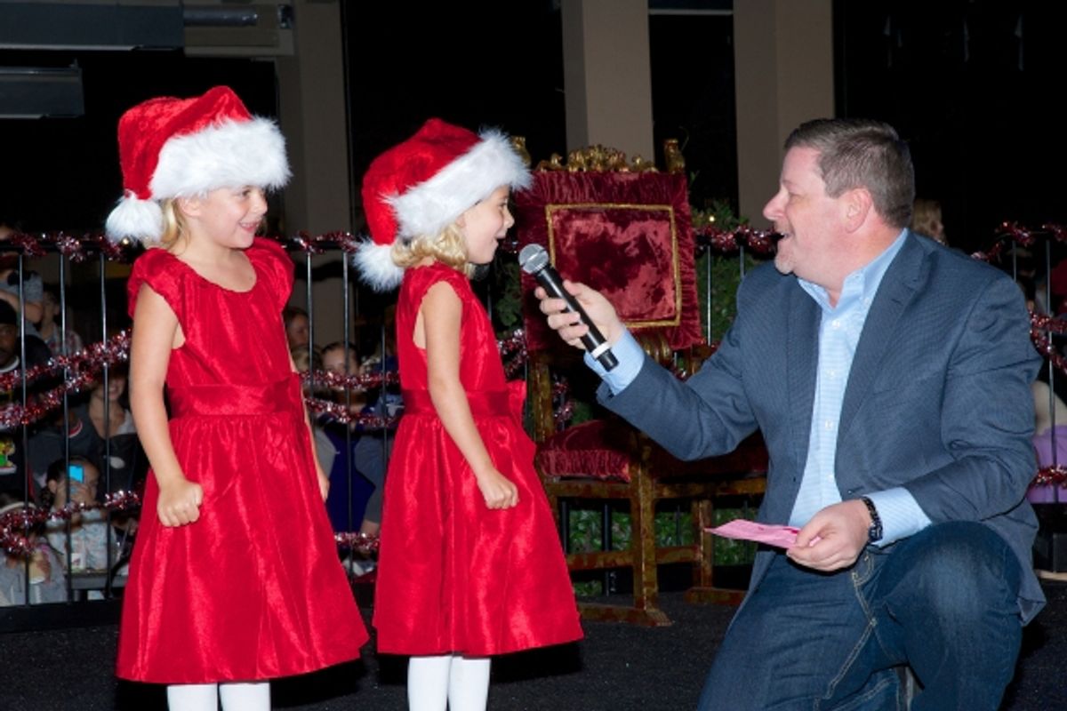 Santa for a Day contest winner Nicole La Fond and her twin sister Natalie (pictured here with Old Globe Managing Director Michael G. Murphy) helped light the tree at 