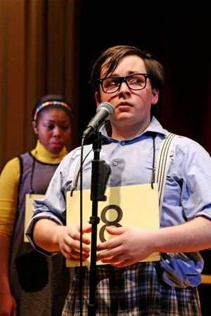 BFA Sophomore Ryan Leaf steps up to the microphone, while BFA Senior Whitney Andrews  Photo