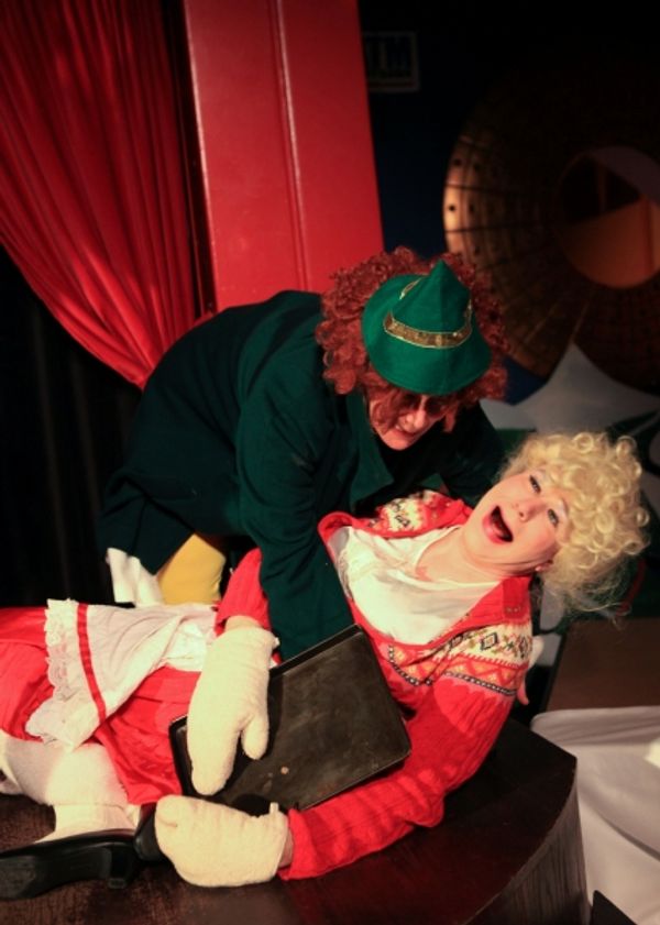 Elfina (Barbara Figgins) tries to help a drunken Ruth Claus (Ed Jones) off the floor Photo