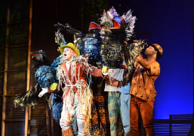 The Scarecrow (David LaMarr, center) is surrounded by crows (puppets controlled and v Photo