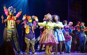 Badia Farha, center, as Addaperle, and Destinee Rea, as Dorothy, surrounded by Munchkins (puppets controlled and voiced by members of the cast). @ BroadwayWorld Badia Farha, center, as Addaperle, and Destinee Rea, as Dorothy, surrounded by Munchk Photo