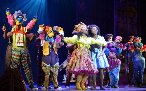 Badia Farha, center, as Addaperle, and Destinee Rea, as Dorothy, surrounded by Munchk Photo