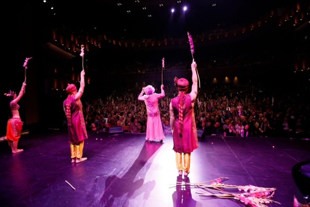 Dame Edna and the cast throw gladiolas to the audience at 