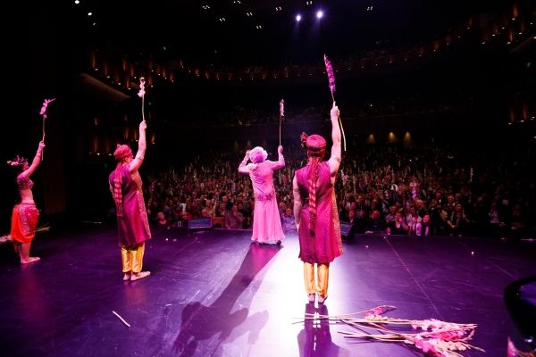 Dame Edna and the cast throw gladiolas to the audience Photo