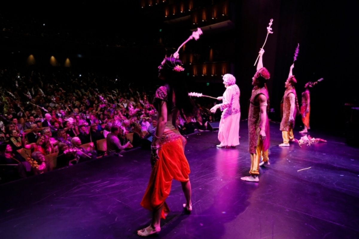 Dame Edna and the cast throw gladiolas to the audience at 