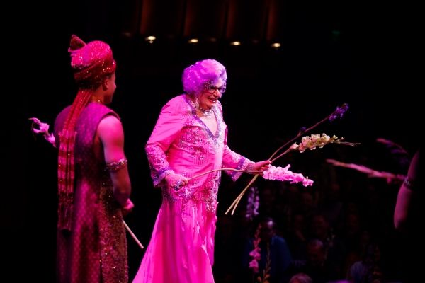 Dame Edna and the cast throw gladiolas to the audience Photo