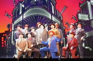 Kelly Green (Nathan Detroit) and the male ensemble Photo