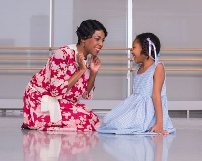 Denise Collins tells Milan Williams a story Photo