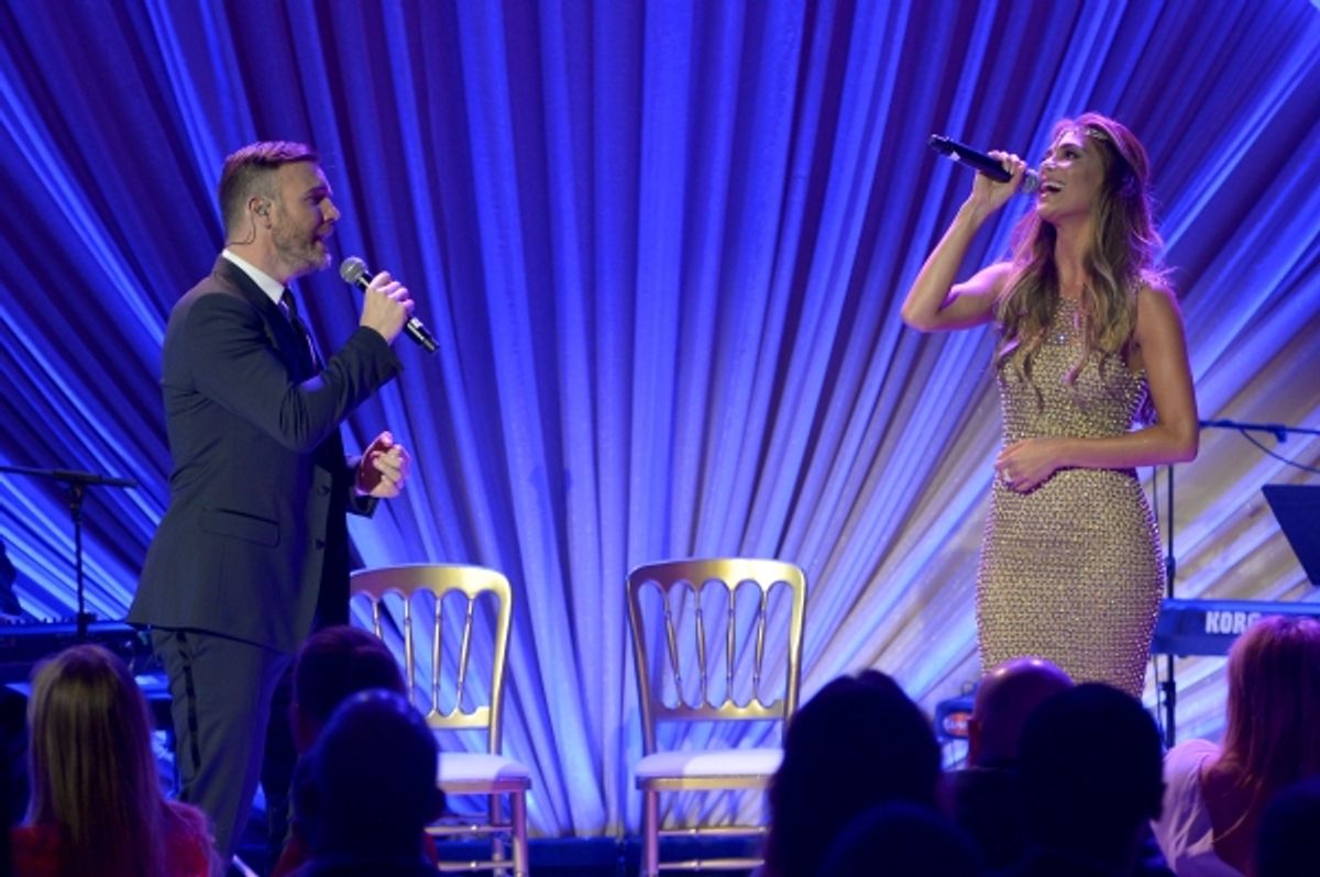 LOS ANGELES, CA - FEBRUARY 21:  Singers Gary Barlow (L) and Nicole Scherzinger perform onstage during The Weinstein Company's Academy Awards Nominees Dinner in partnership with Chopard, DeLeon Tequila, FIJI Water and MAC Cosmetics on February 21, 2015 in at 