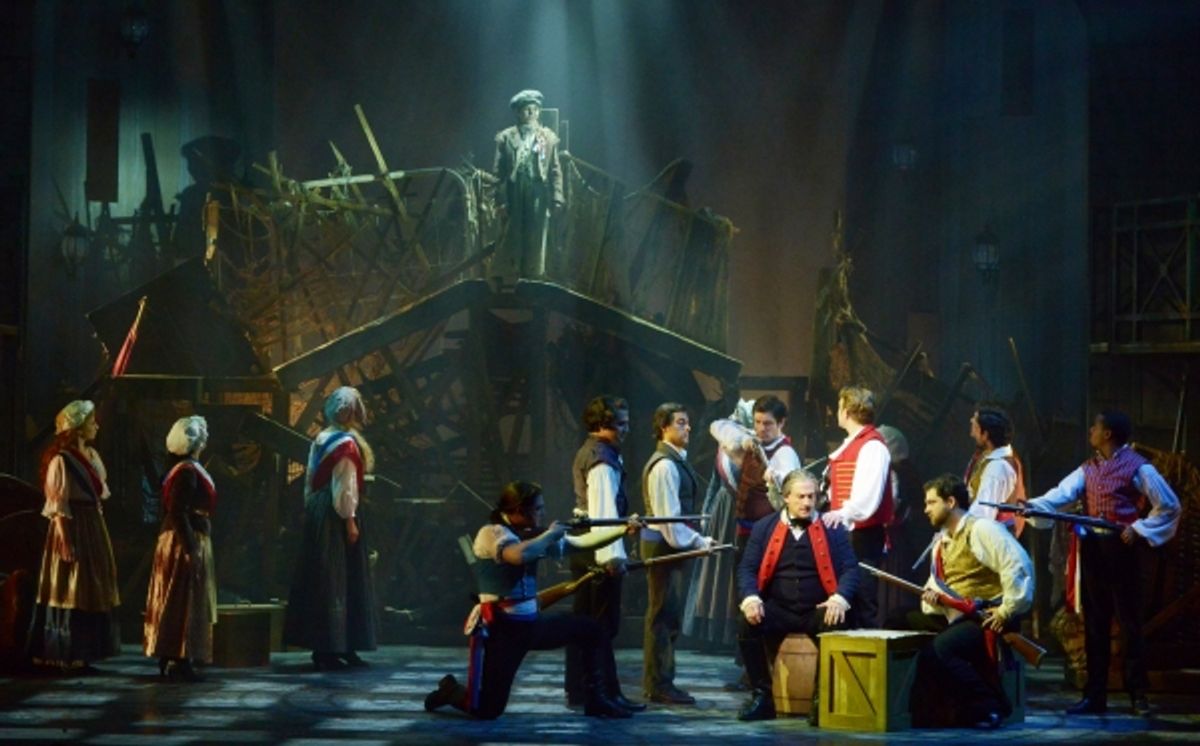 Citizens surround Javert (Aoysius Gigl), seated, as he is caught in a lie in the Maltz Jupiter Theatreâ€™s production at 