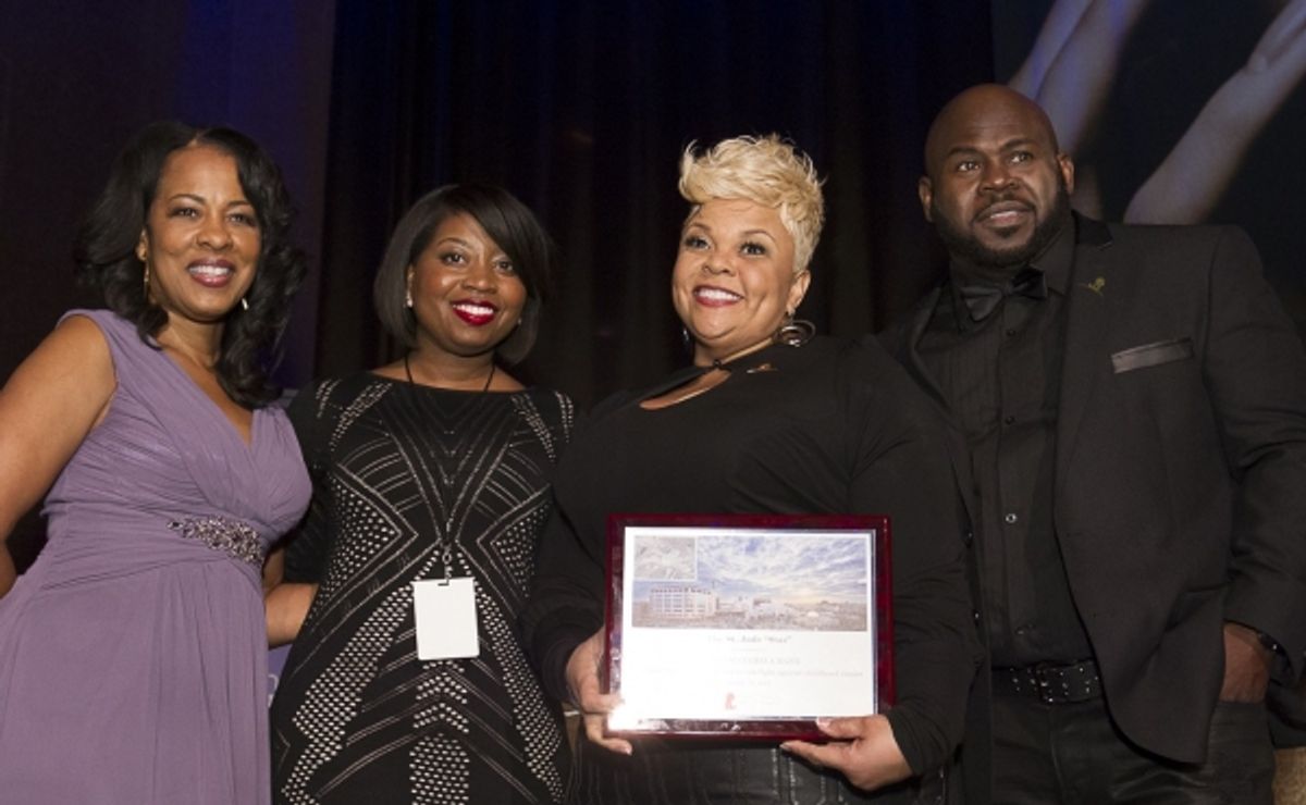 St. Jude Radio Cares Advisory Council member Monica Bacon and St. Jude rep Carmen Triplett-Watson present Tamela and David Mann with the St. Jude Star Award at the eOne Music post-Stellars Award Celebration. at 