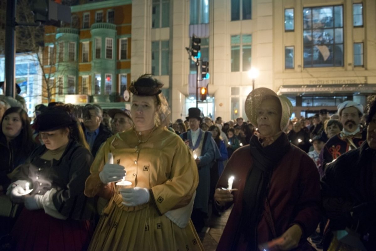 Crowds gather on Tenth Street NW outside of Fordâ€™s Theatre to honor Abraham Lincoln with a
candlelight vigil on the night of April 14, 2015.


 at 