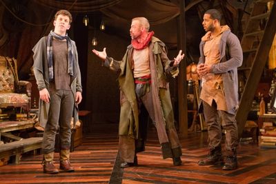 The Player (Ian Merrill Peakes, center) tries to share his wisdom with Guidenstern (A Photo