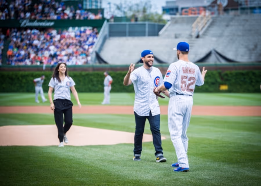 Exclusive Photo Coverage: ON YOUR FEET Stars Ana Villafañe and Josh Segarra Throw Out First Pitch at Chicago Cubs Game Image