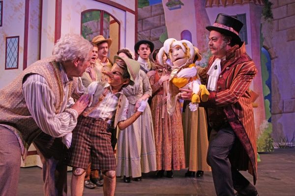 Geppetto (Nicholas F. Saverine) and Pinocchio (Topher Cundith) meet the puppeteer Str Photo
