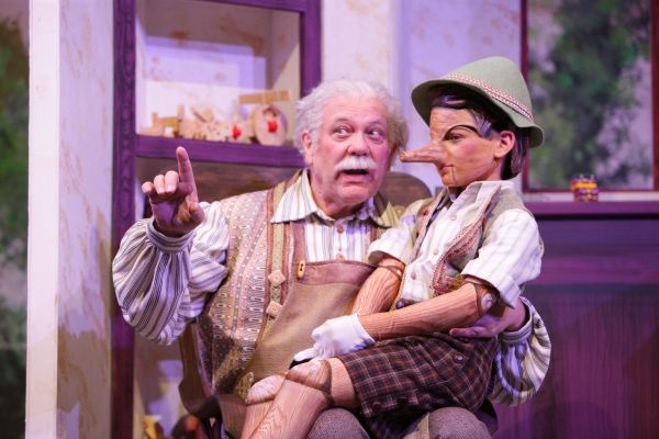 Geppetto (Nicholas F. Saverine) gets to know his new son Pinocchio (Topher Cundith). Photo