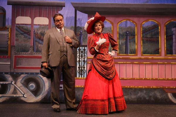 Matchmaker Dolly Levi (Kathryn Kendall) assures Horace Vandergelder (Bill Nolte) that Photo