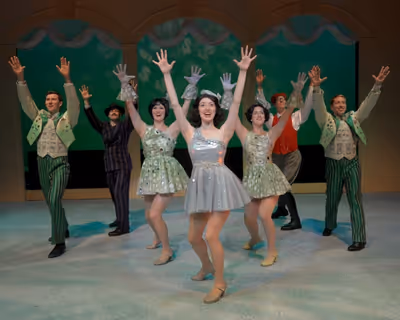 Darien Crago (center as Ginger Rogers) and ensemble perform 'We're In The Mon Photo