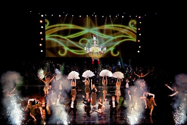 Christopher Biggins flies in as a chandelier in ''Be Our Guest'' Photo