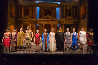Christopher Fitzgerald (in red, fifth from left) as Pseudolus and the company of A FU Photo