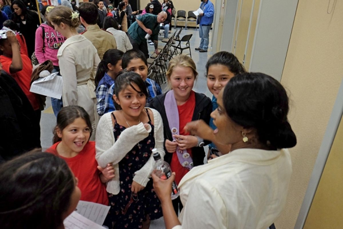Young audience members discuss the show with Monique Gaffney after a performance for South Bay Community Services at Castle Park Elementary School at 