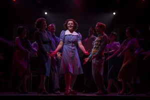 Ruby Rakos (center) and company Photo