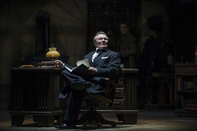 Jonathan Smoots as Ebenezer Scrooge and Jonathan Wainwright (background) as Bob Cratc Photo