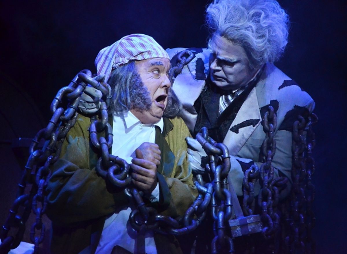 Ebenezer Scrooge (Eddie Curry), left, is horrified to learn that the fate that befell his business partner Jacob Marley (Daniel Klingler) could also be his own at 