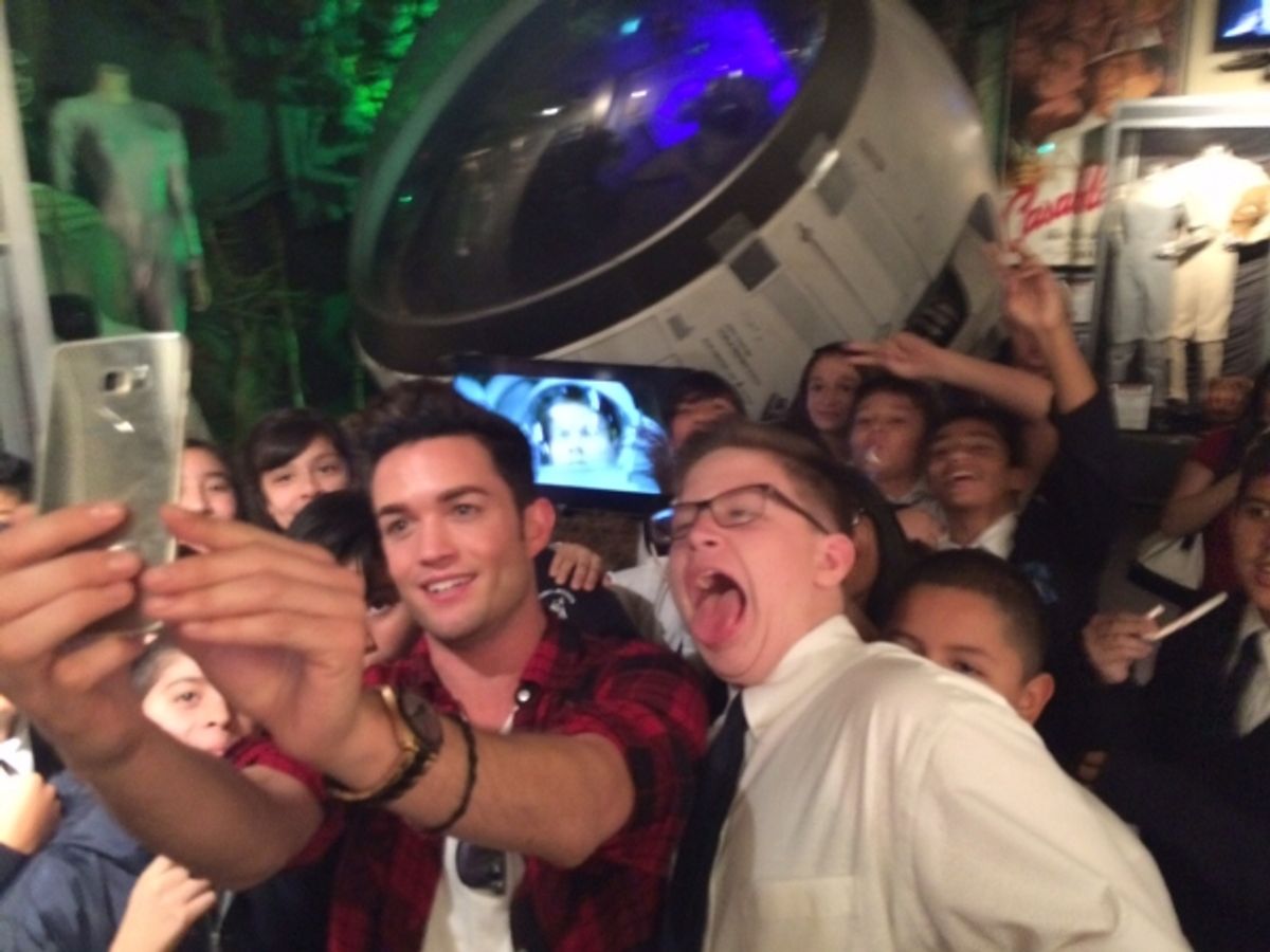 Chris Trousdale takes selfies with students of Dolores Mission School at 