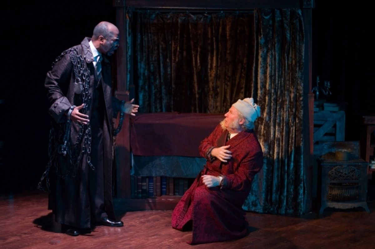 Marcus Denard Johnson as Jacob Marley and Michael Selkirk as Ebenezer Scrooge. at 
