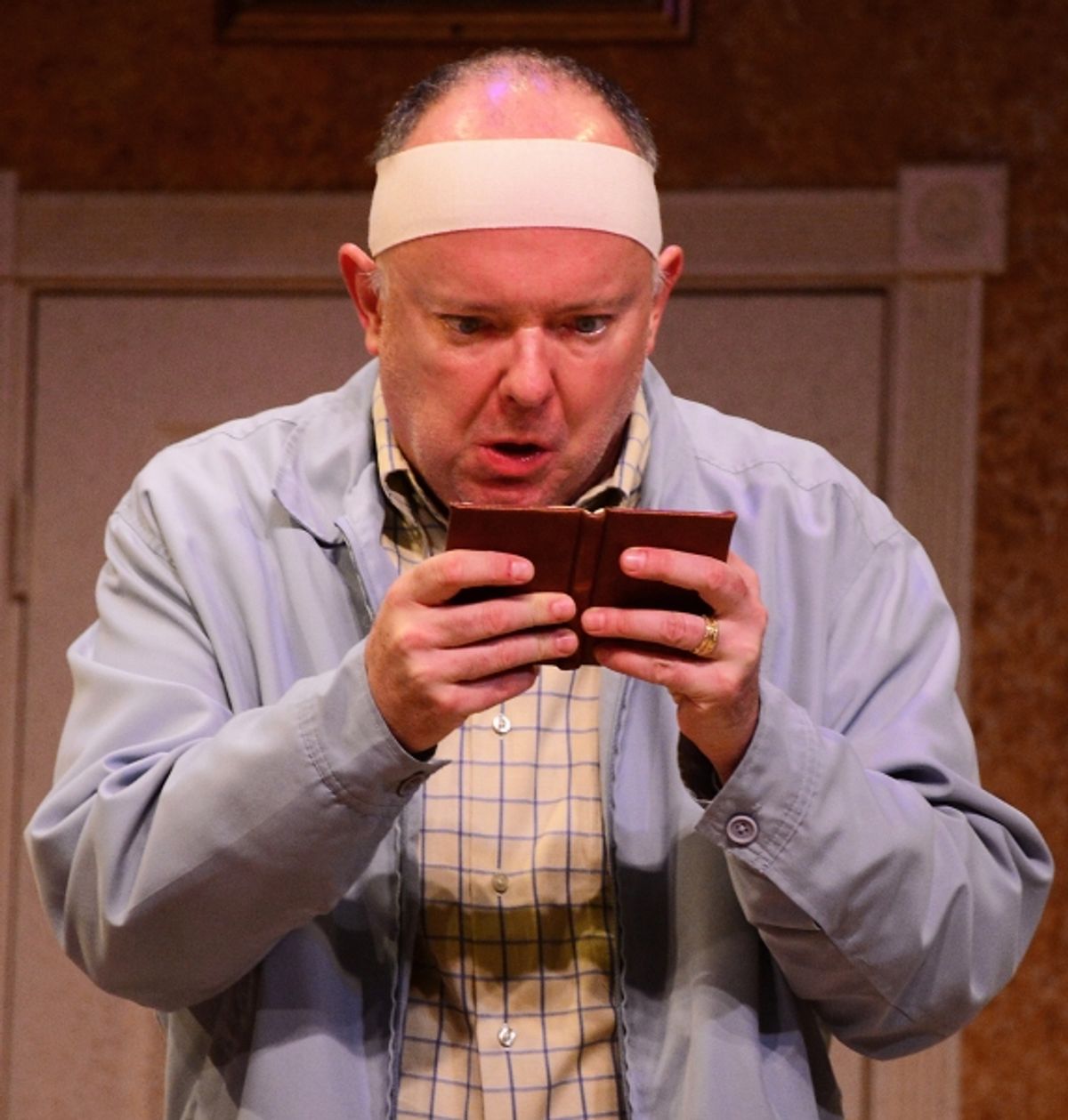 John Smith (Eddie Curry) frantically checks his schedule. at 