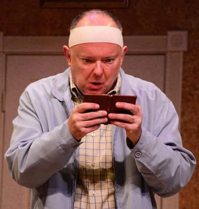 John Smith (Eddie Curry) frantically checks his schedule. Photo