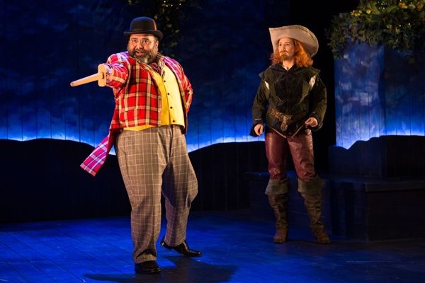 Bottom (Holly Twyford) looks on as Peter Quince (Richard Ruiz) surprisingly takes cen Photo