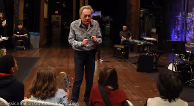 Andrew Lloyd Webber speaks with some School of Rock auditionees Photo