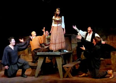 The Muleteers tease Aldonza for being mistaken as Don Quixote's 'Dulcinea.' From left Photo