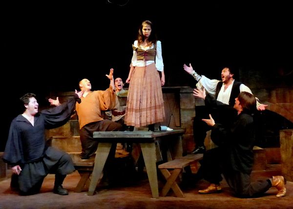 The Muleteers tease Aldonza for being mistaken as Don Quixote's 'Dulcinea.' From left Photo