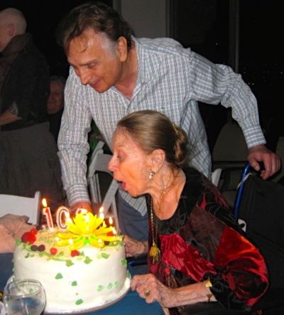 Party host, celebrated director John Bowab, stands by as Patricia Morison blows out h Photo