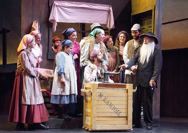 The Rabbi (Ron Rudolph) blesses Motel's new sewing machine. Photo